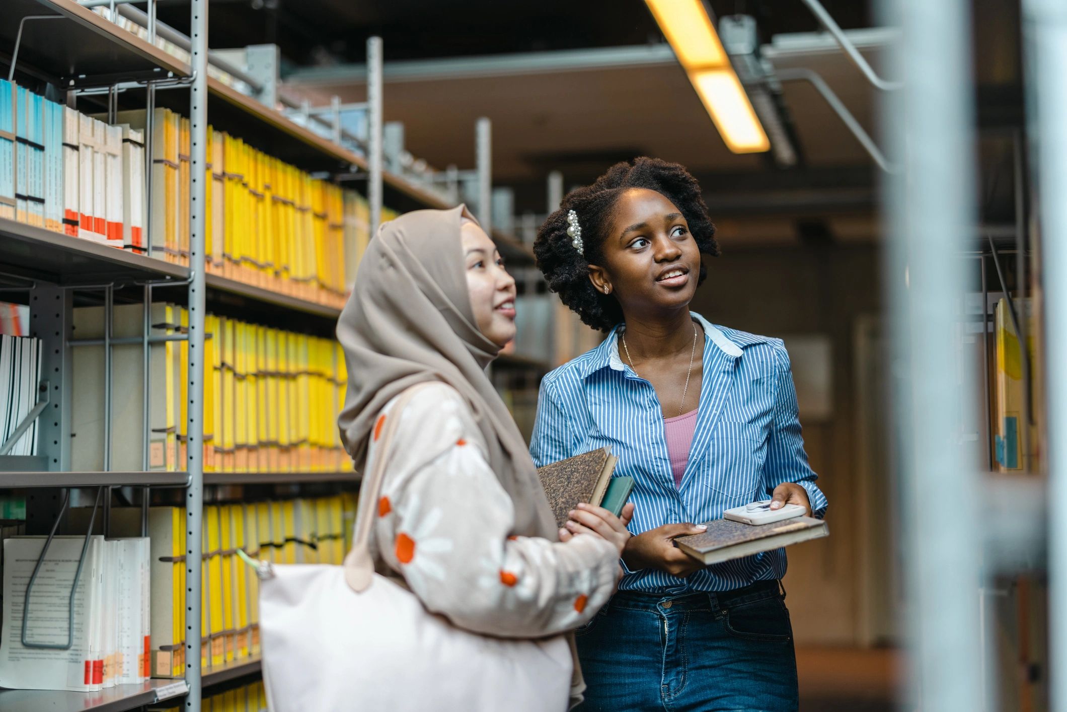 University students standing together in a library