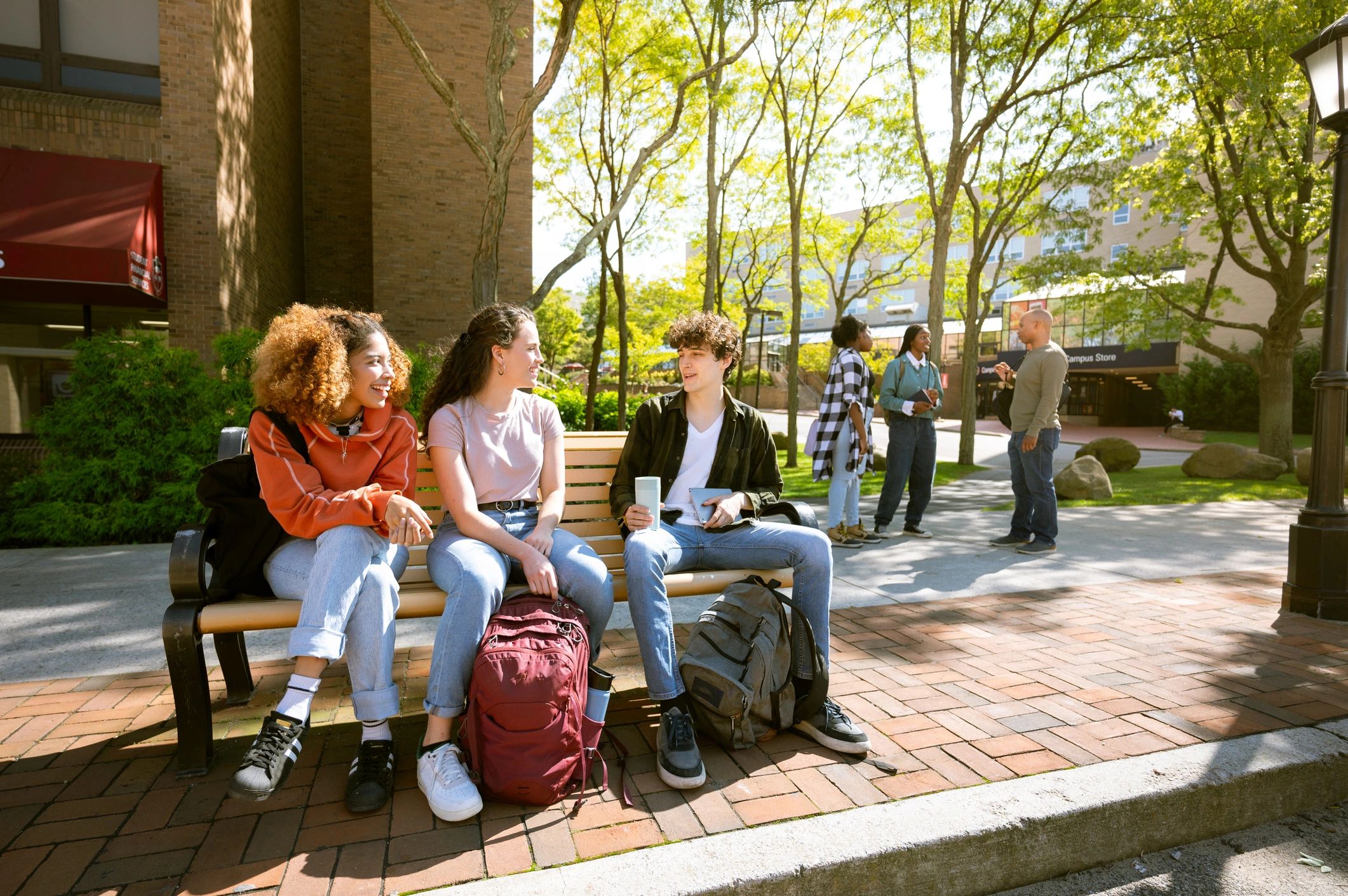 University students waiting at a campus bus stop