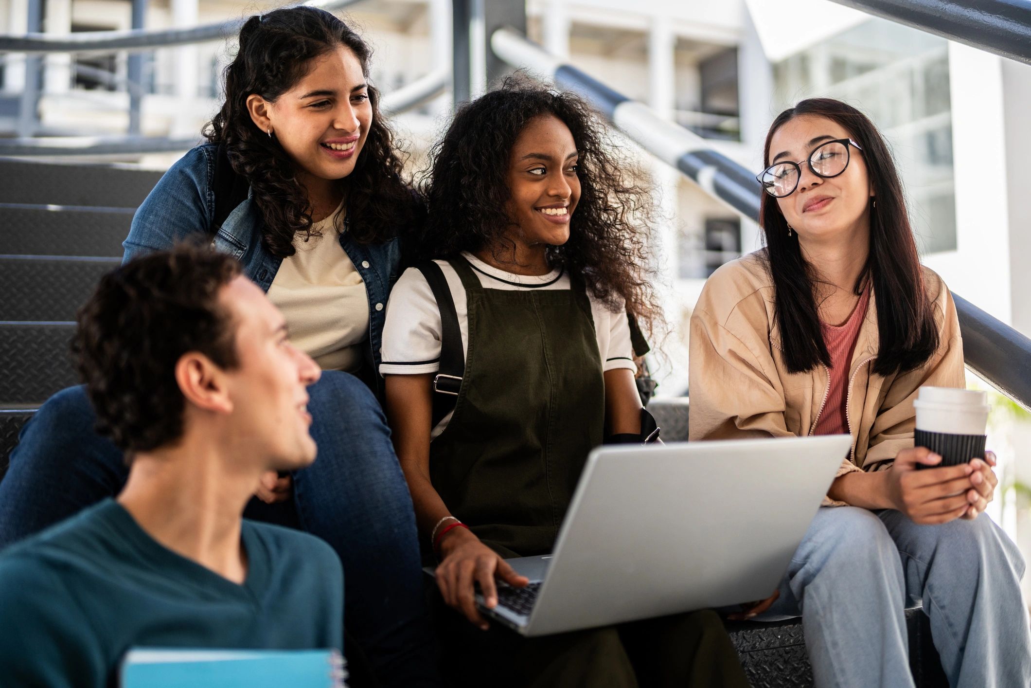 University students collaborating with a laptop