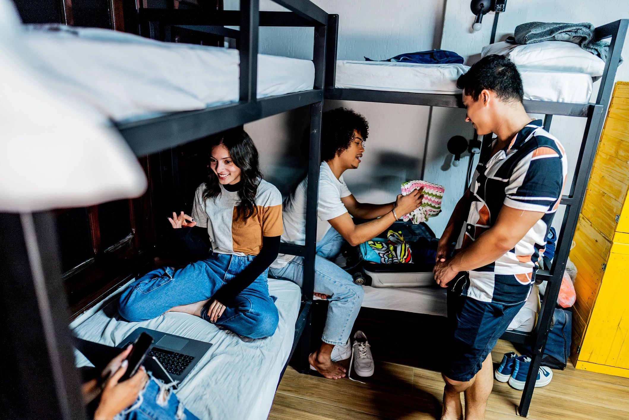 Happy college friends talking in a residence hall