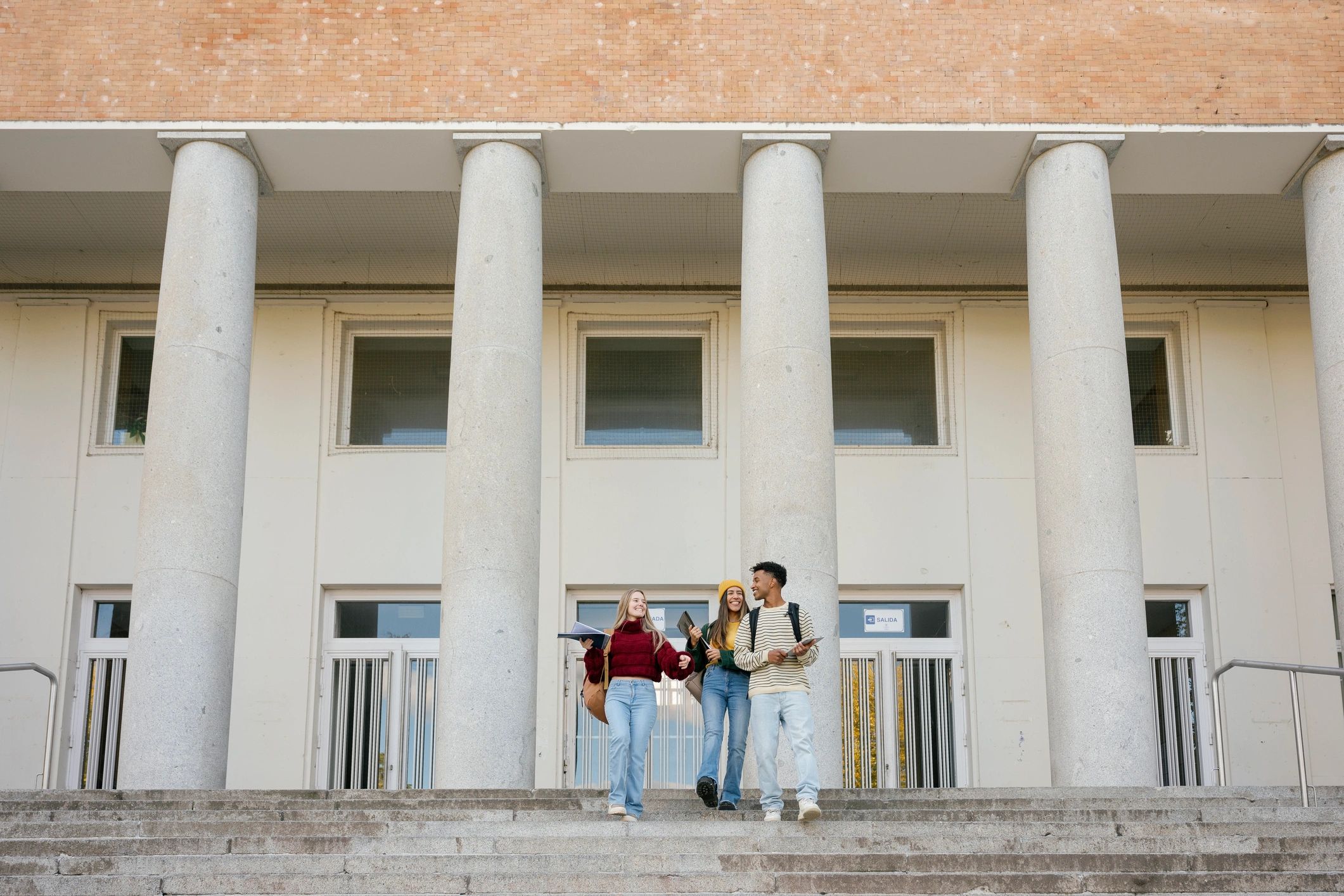 Diverse university students walking together on campus