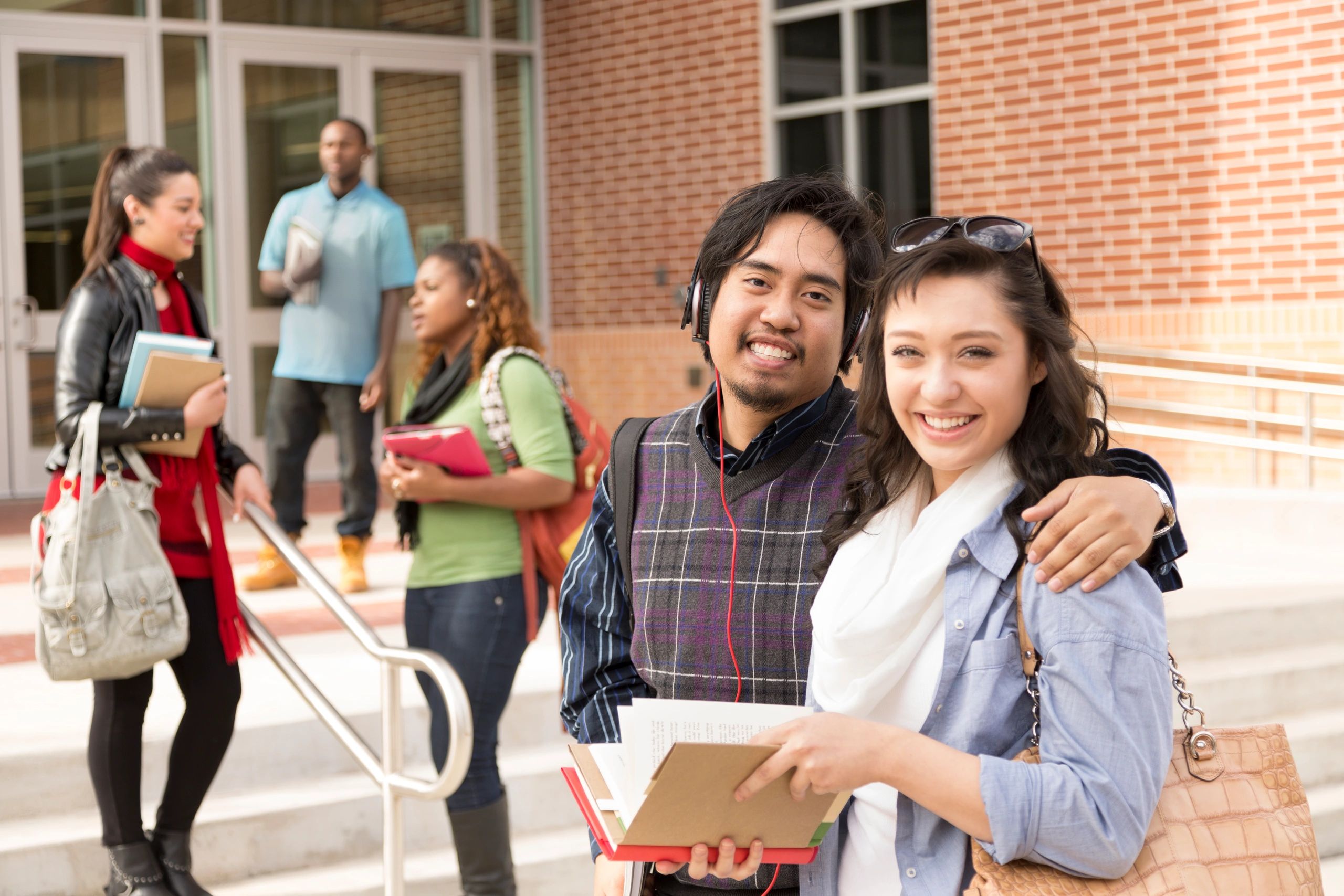 Happy college friends spending time together before class